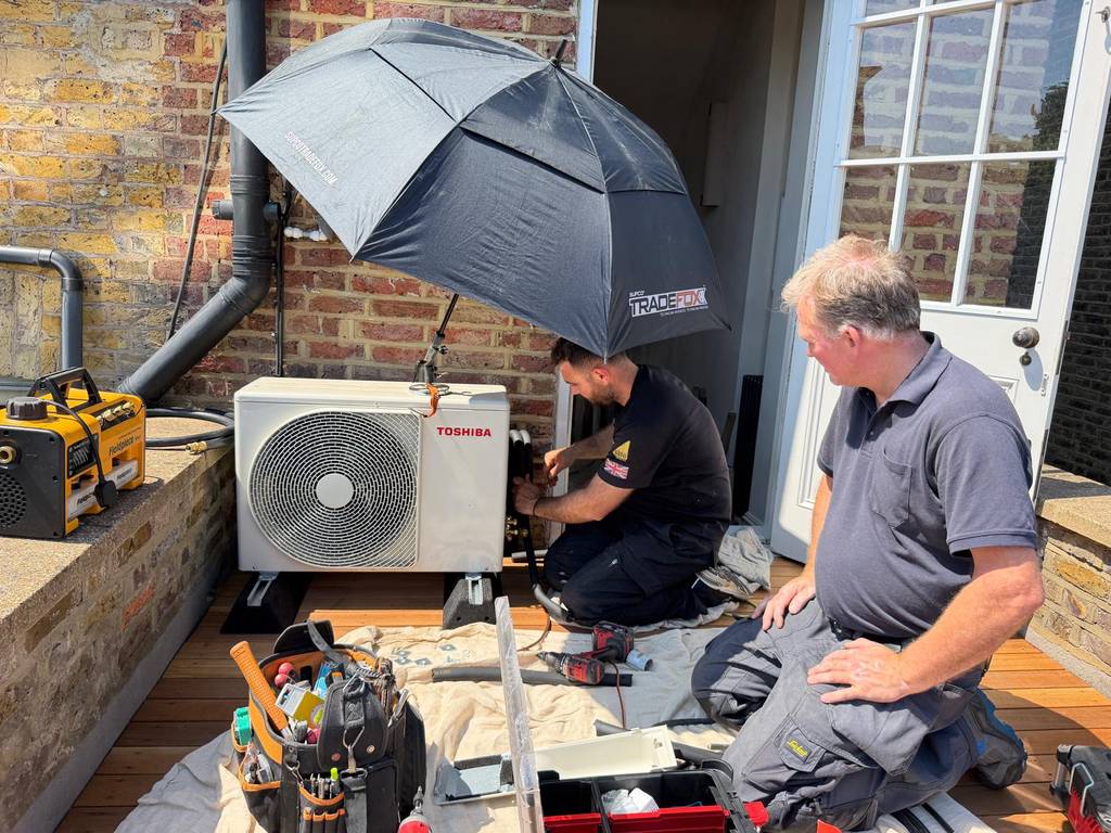 Warm & Cool London engineers installing Toshiba outdoor condenser on roof terrace