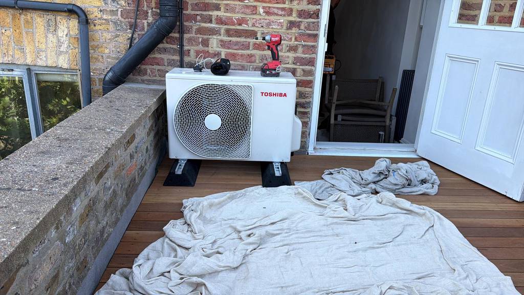 Toshiba outdoor condenser unit neatly installed on timber decking