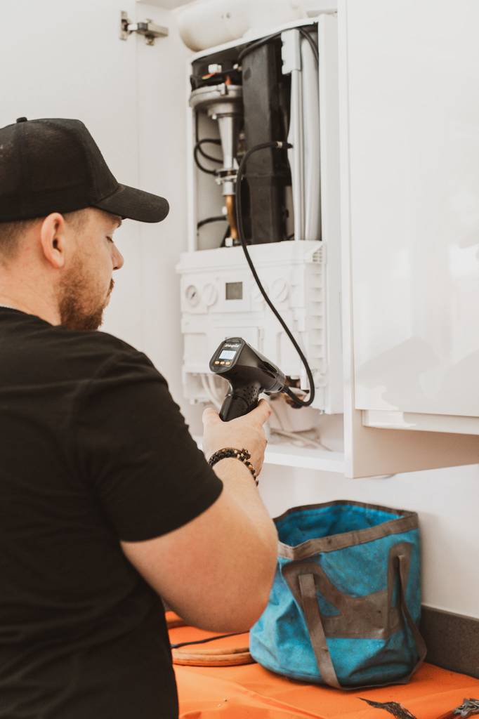 Testing boiler pressure and gas readings with testing equipment