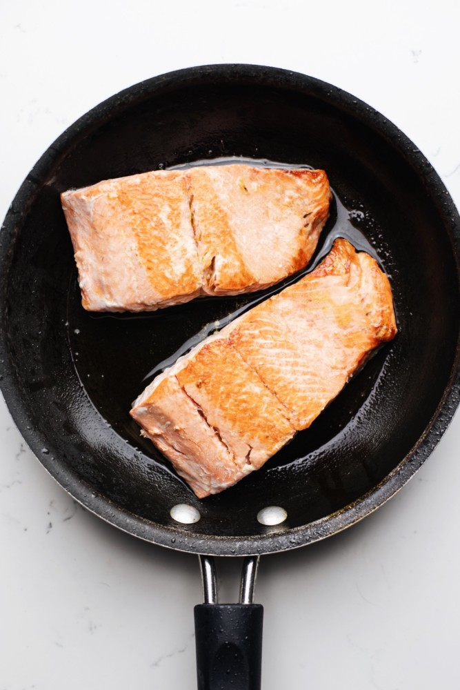 Citrus glazed salmon in a frying pan