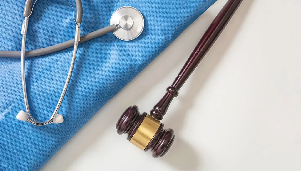 Photo of scrubs and stethoscope and gavel