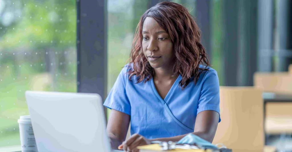 Nurse working on a computer on her online certification