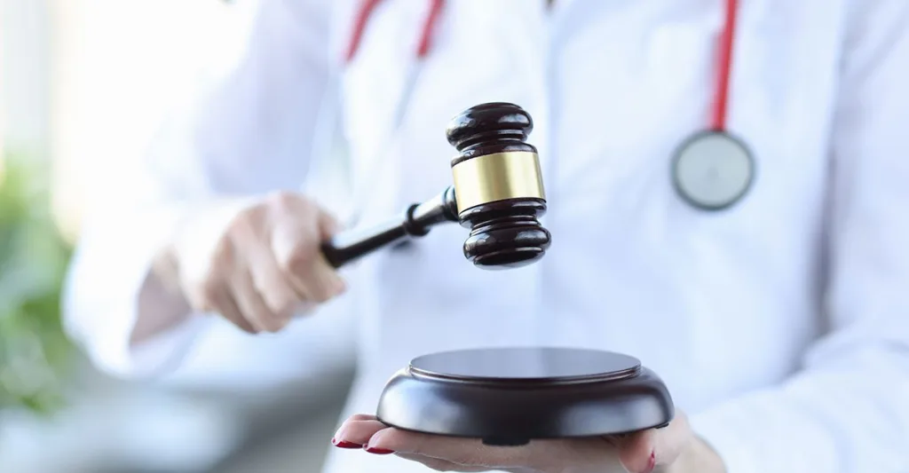 Nurse in lab coat with gavel