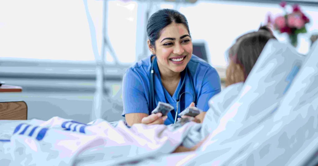 Nurse talking to patient in hospital bed