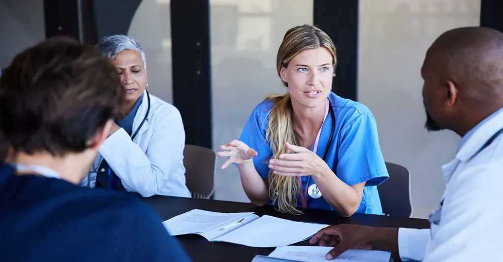 Nurses and other healthcare professionals in a meeting