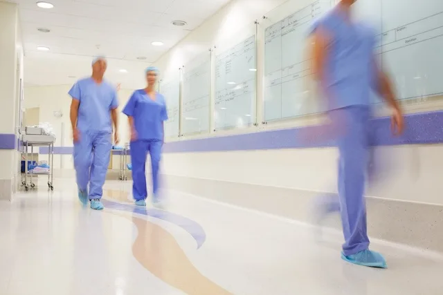 ER nurses moving quickly in hallway