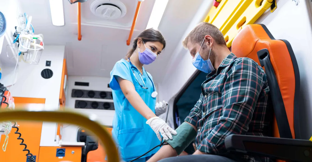 Nurse attending to patient in ambulance