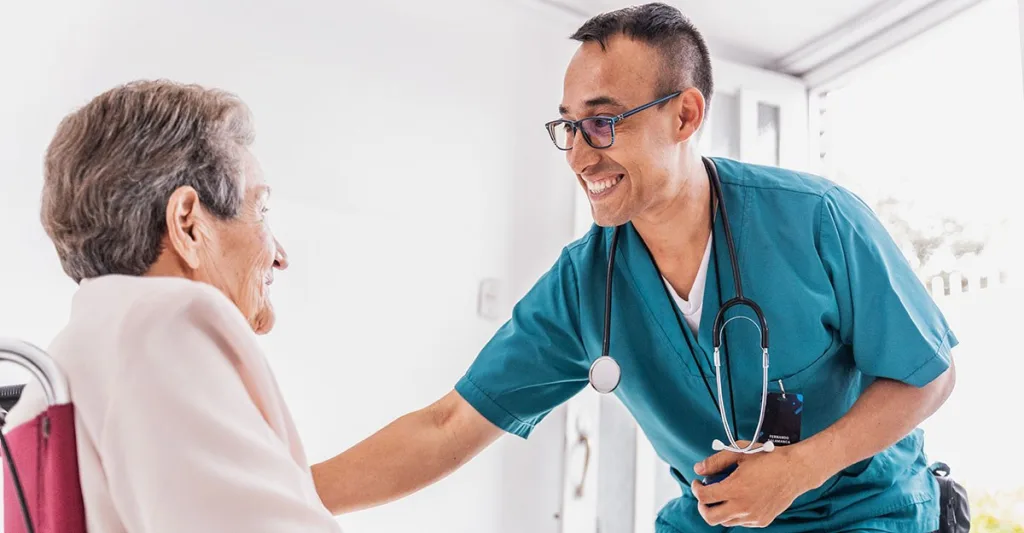 Male nurse helping patient