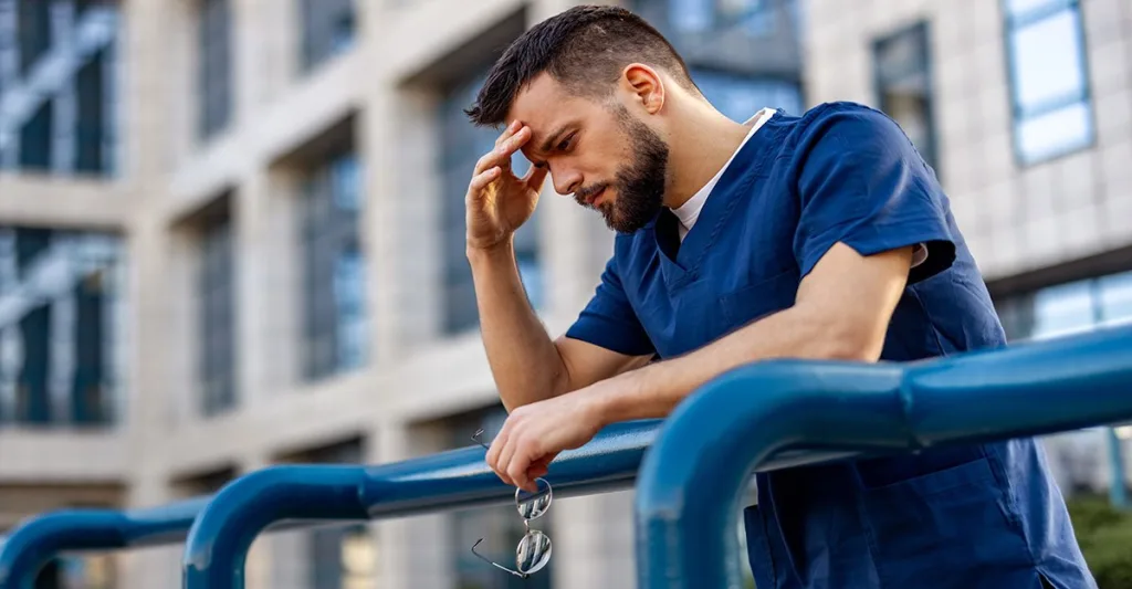 Male nurse dealing with burnout