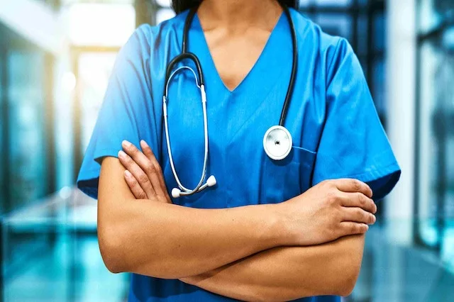 Female nurse in scrubs wearing best stethoscope for nurses around neck