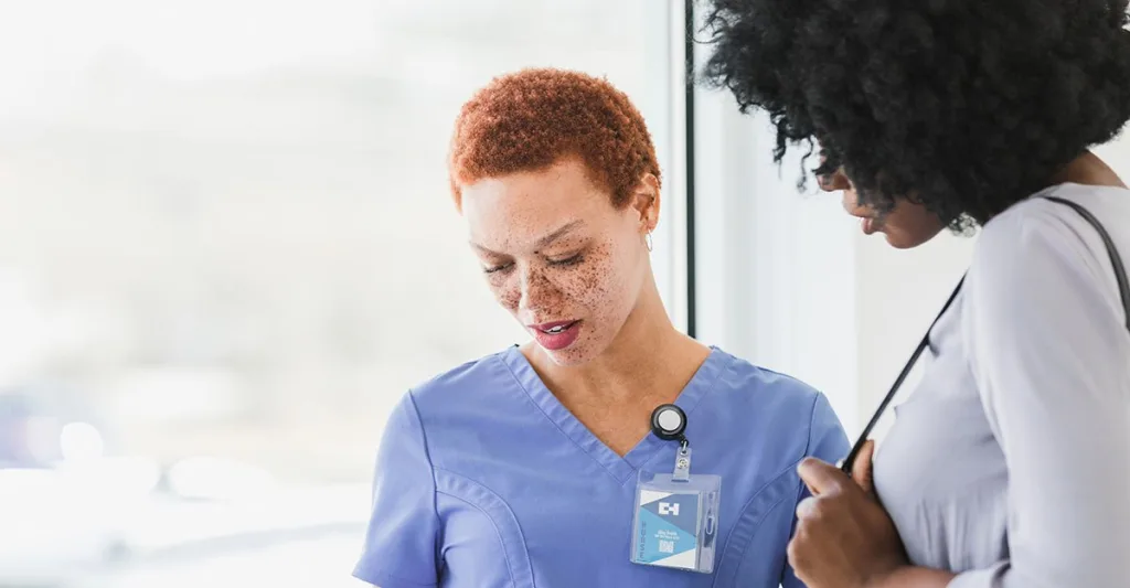 Nurse wearing a nurse badge reel