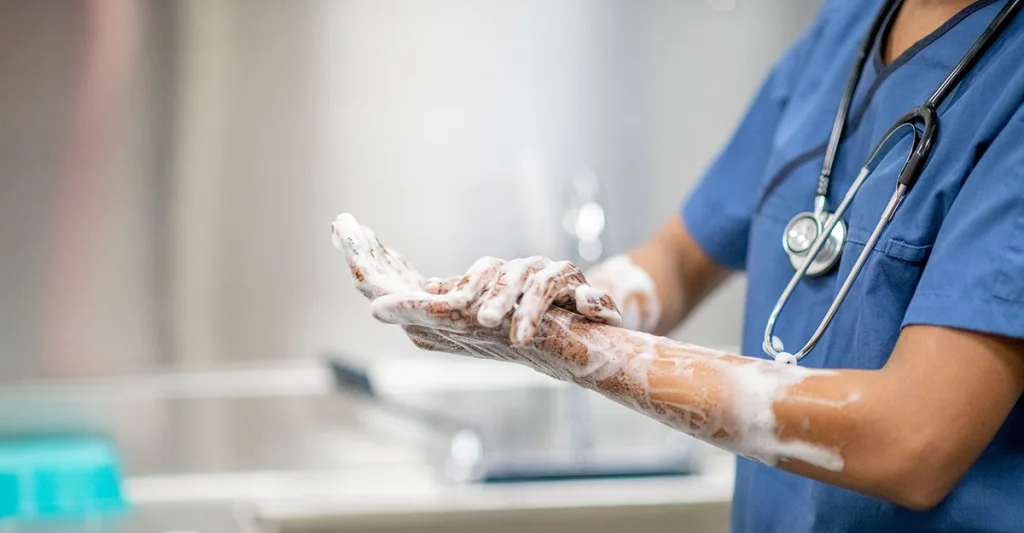 Hand washing nurse wearing a stethoscope