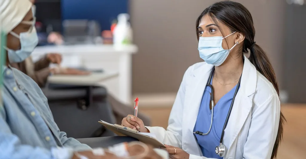 Oncology nurse helping a patient during a clinical trial