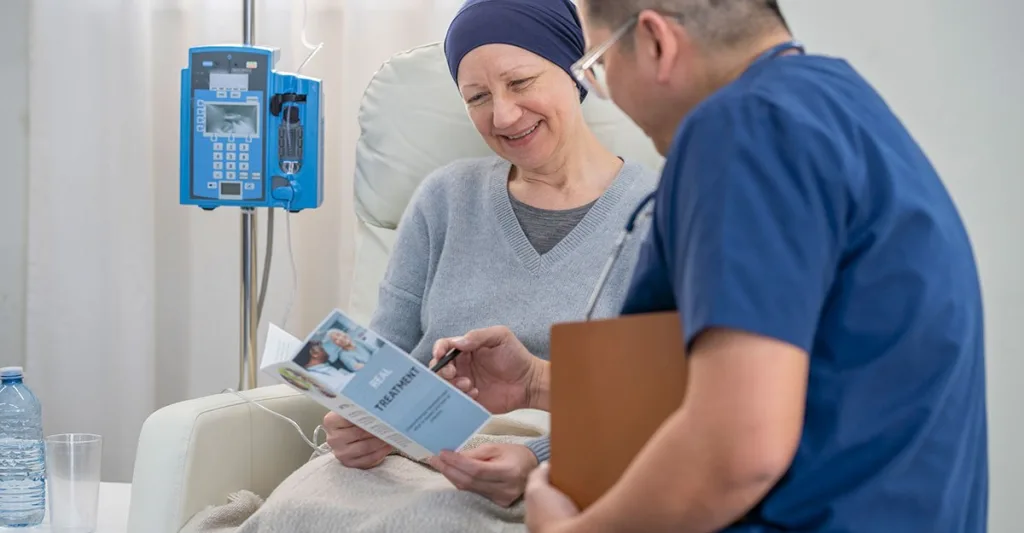 Oncology nurse educating patient undergoing cancer treatment