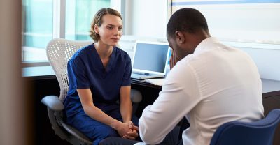 A nurse looking at a patient