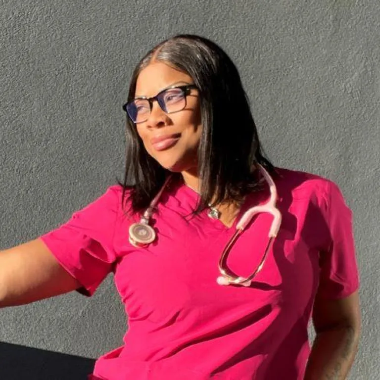 Portrait of a nurse in pink scrubs wearing a stethoscope