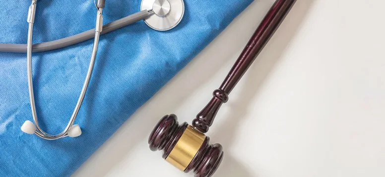 Photo of scrubs and stethoscope and gavel