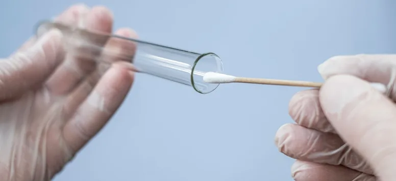 Forensic nurse uses swab to collect evidence