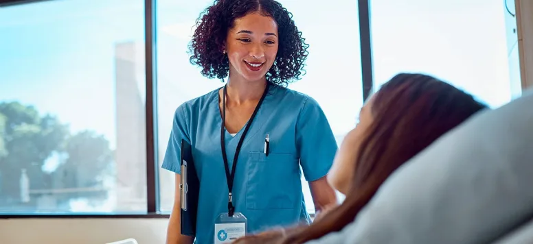 Nurse talking with patient at bedside