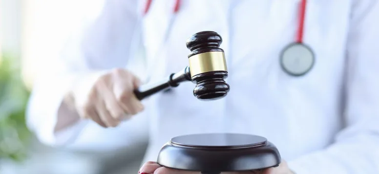 Nurse in lab coat with gavel