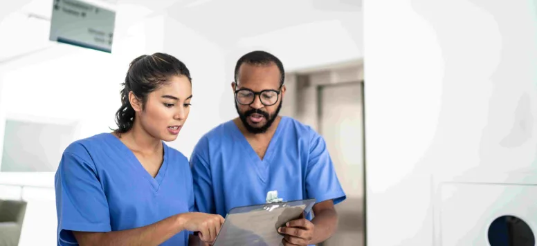 Two nurses reviewing a chart