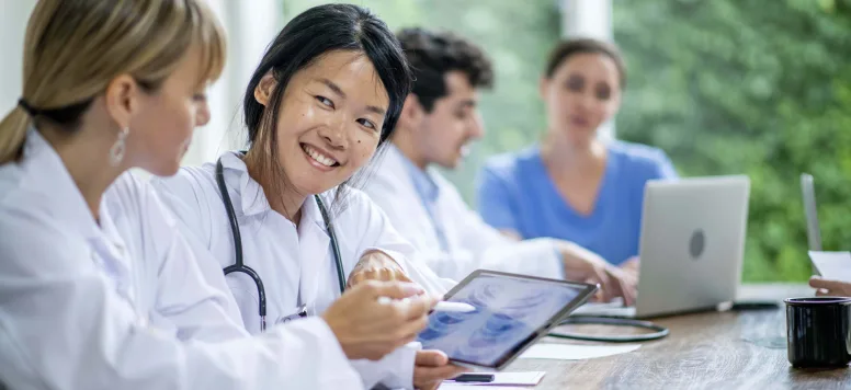 Nurses in a nurse residency program sitting at a table studying