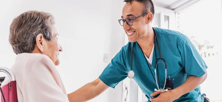 Male nurse helping patient