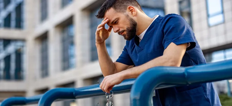 Male nurse dealing with burnout