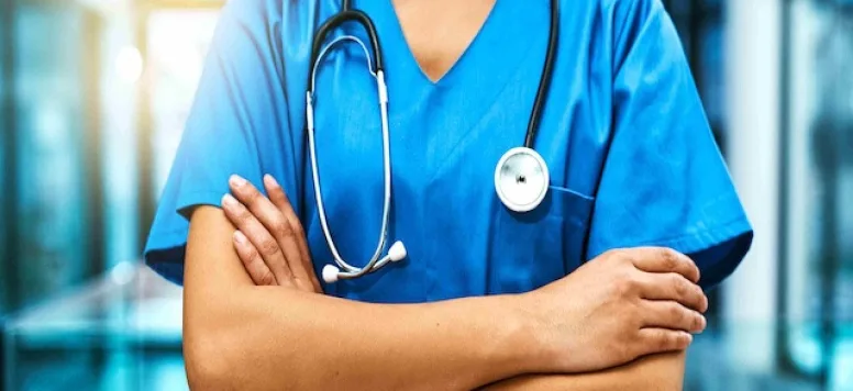 Female nurse in scrubs wearing best stethoscope for nurses around neck