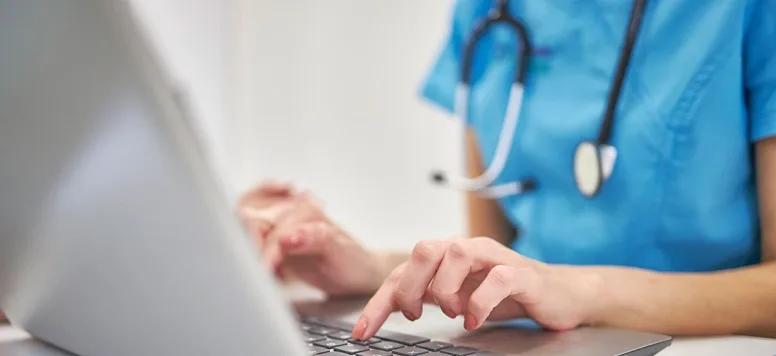 Nurse working in nursing informatics on computer