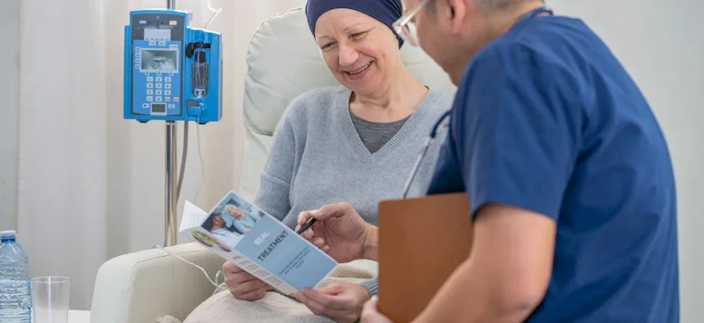 Oncology nurse educating patient undergoing cancer treatment