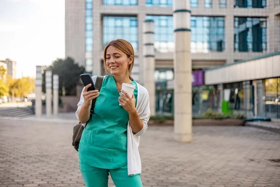 Nurse checking her phone after work