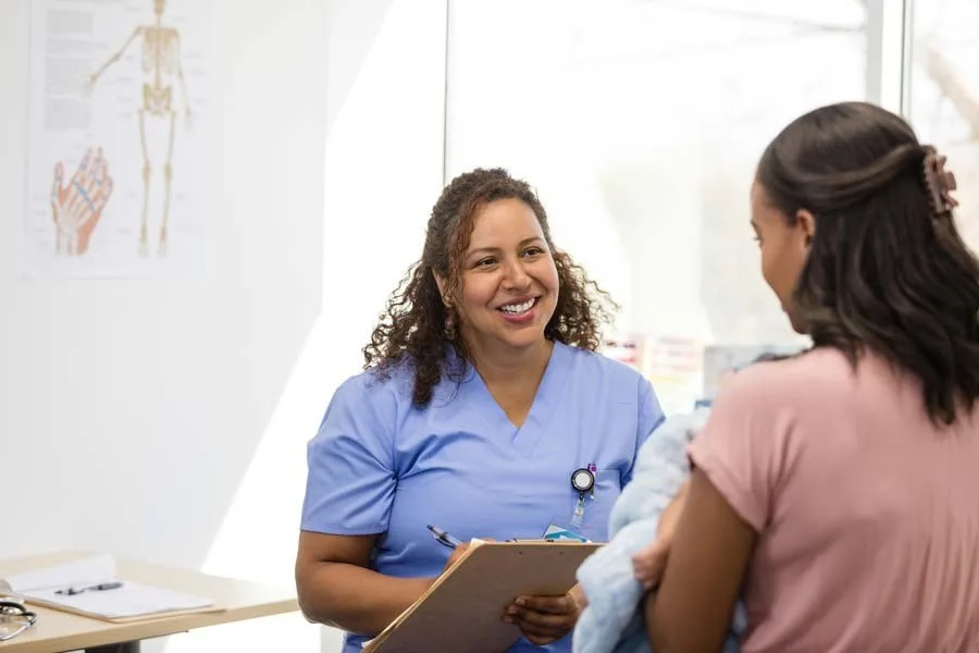 Nurse talking with patient in doctors office