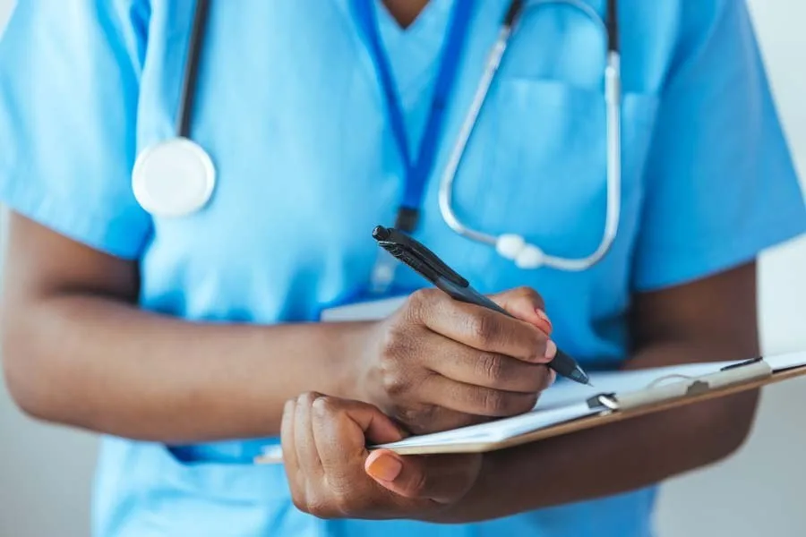 Nurse taking notes on a clipboard