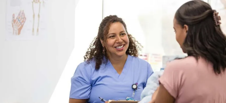 Nurse talking with patient in doctors office