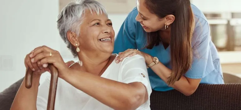 Nurse comforting patient sitting on couch