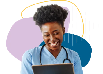 Nurse in blue scrubs smiling at tablet