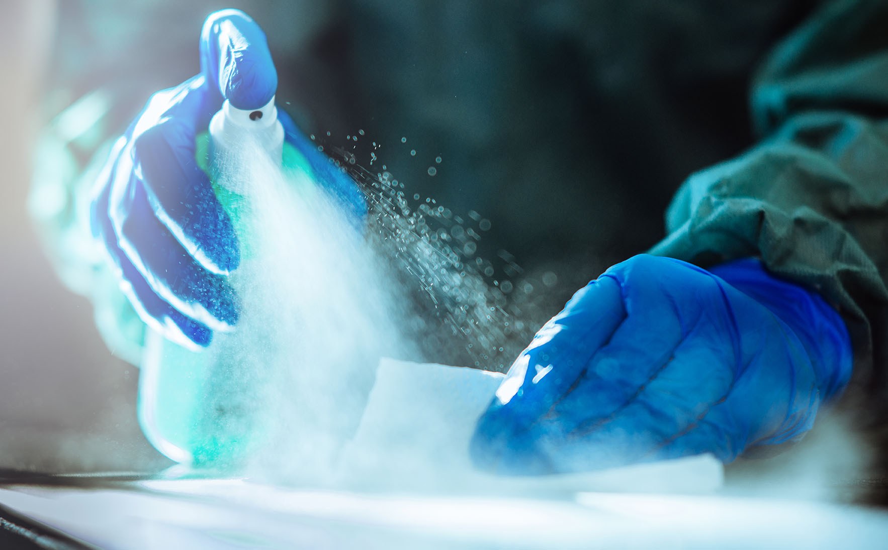 Spraying disinfectant on a surface