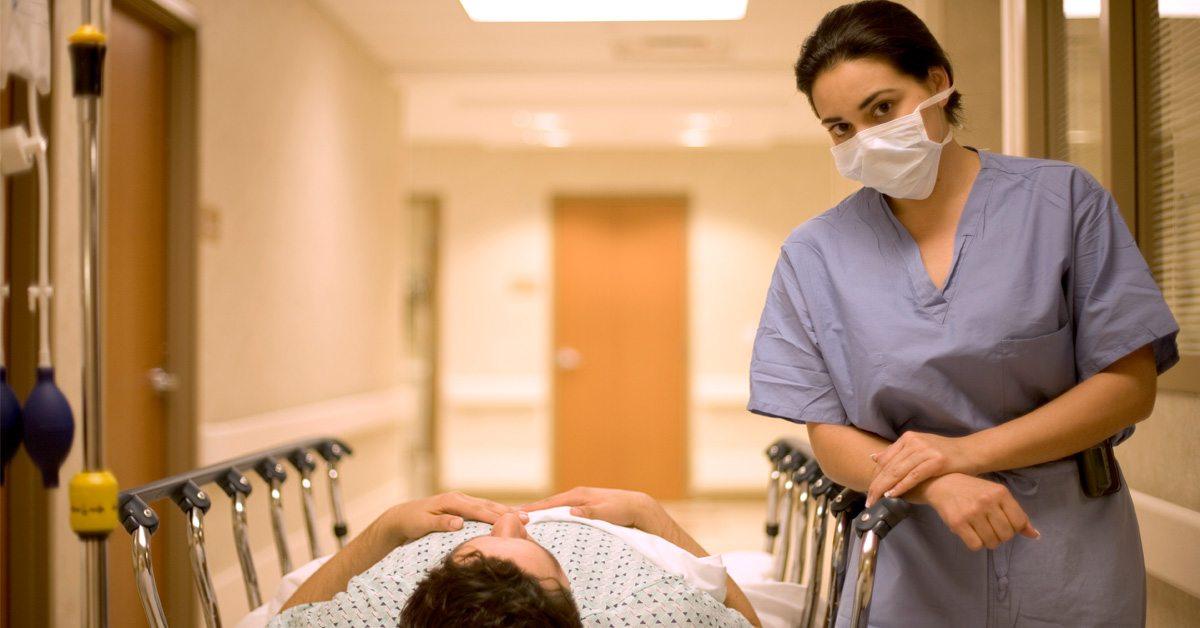 nurse next to patient in a patient bed