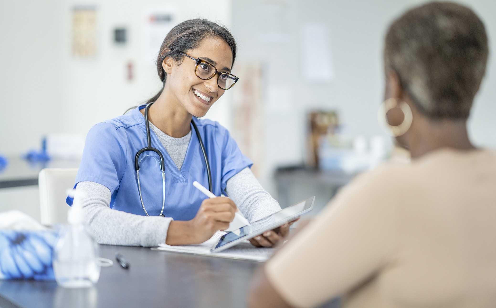 Nurse and patient at a table