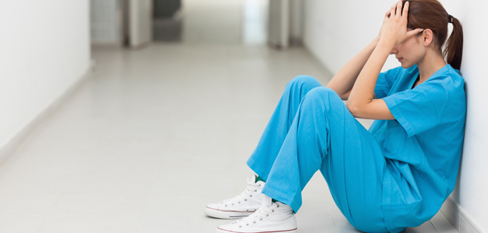 nurse sitting on floor, stressed nurse