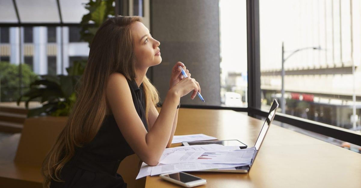 Businesswoman working in an office looking out of the window