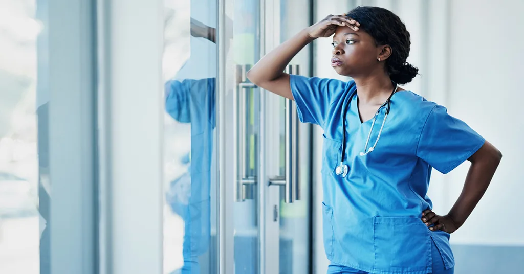 A stressed nurse looking out the window