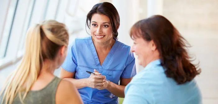 A nurse talking with patient in hallway