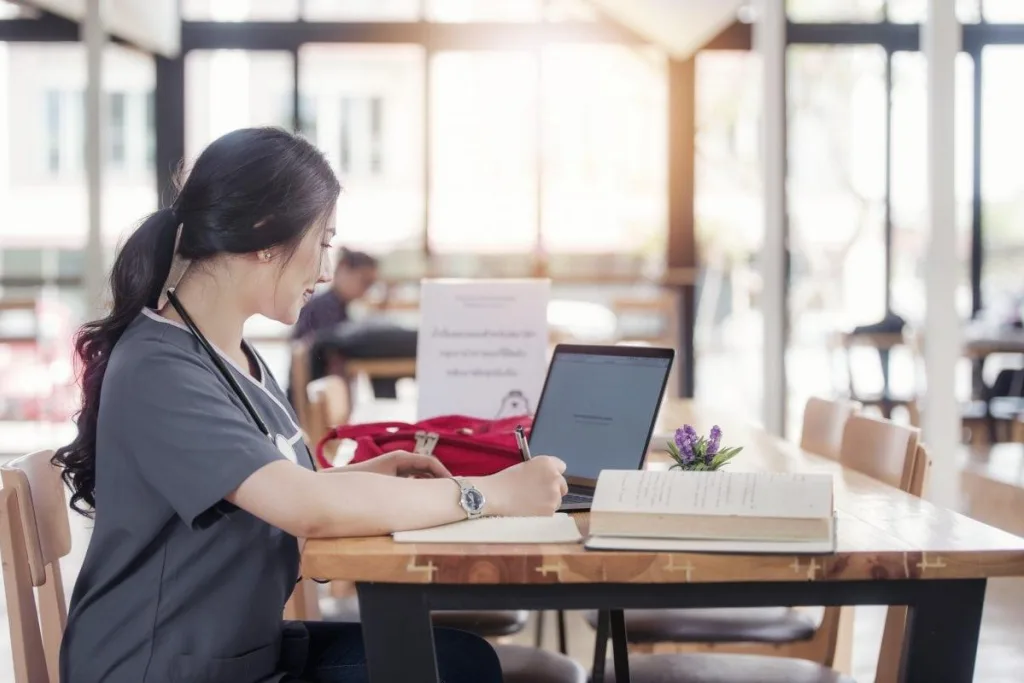 Nurse studying at a computer