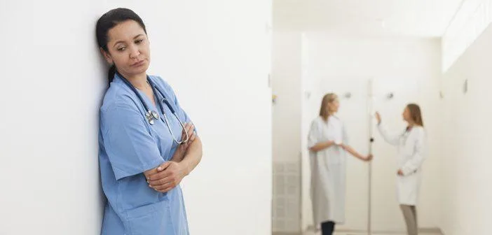 Nurse standing on the wall looking sad