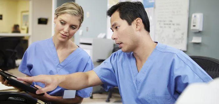 Two nurses reviewing tablet