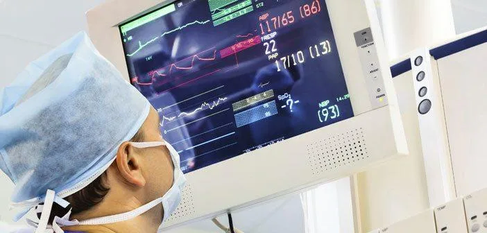 Nurse looking at vitals on a screen