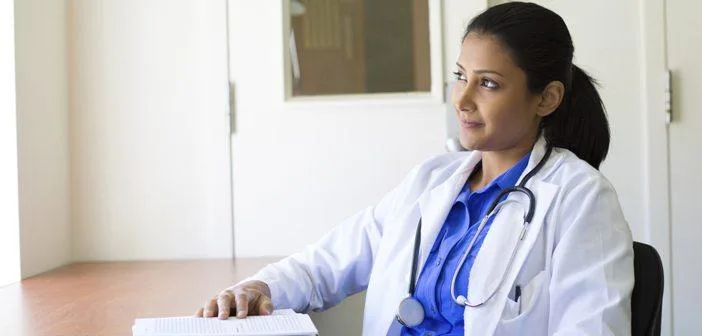 Nurse sitting at a desk looking out the window