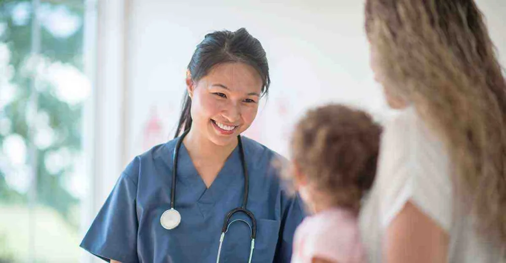 Nurse smiling at young patient